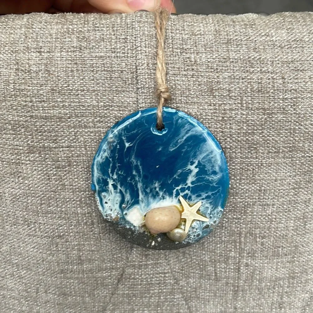Hamdmade Seashell ornament on tree chip